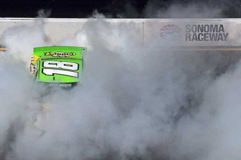 SONOMA, CA - JUNE 28: Kyle Busch, driver of the #18 M&M's Crispy Toyota, celebrates with a burnout after winning the NASCAR Sprint Cup Series Toyota/Save Mart 350 at Sonoma Raceway on June 28, 2015 in Sonoma, California. (Photo by Jonathan Moore/Getty Images) | Getty Images