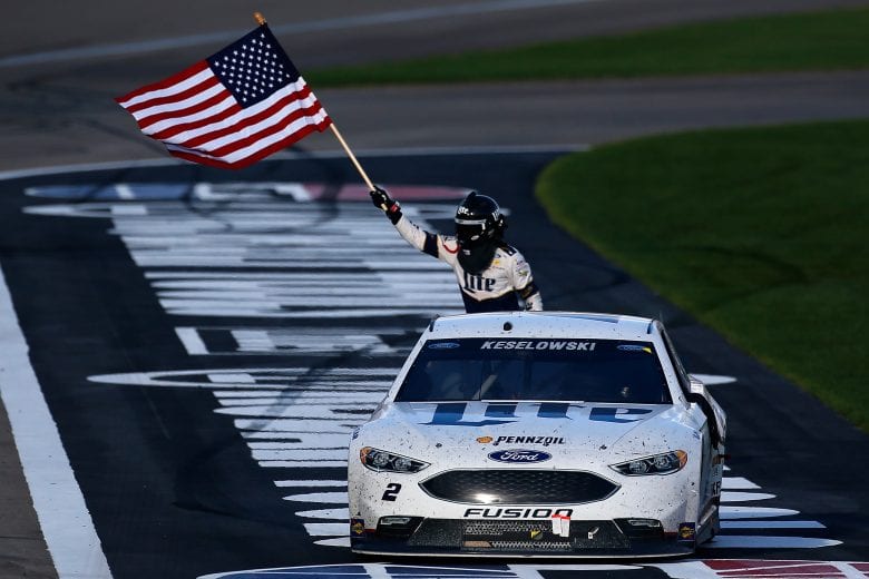 LAS VEGAS, NV - MARCH 06:  Brad Keselowski, driver of the #2 Miller Lite Ford, celebrates with the American Flag after winning the NASCAR Sprint Cup Series Kobalt 400 at Las Vegas Motor Speedway on March 6, 2016 in Las Vegas, Nevada.  (Photo by Jonathan Ferrey/Getty Images) | Getty Images