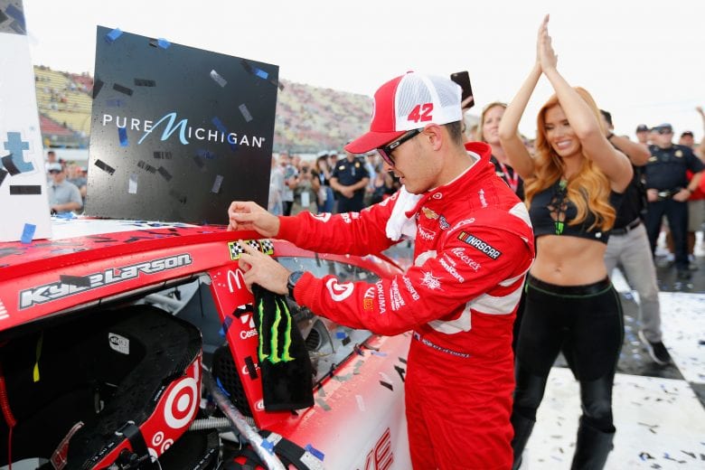 BROOKLYN, MI - AUGUST 13: Kyle Larson, driver of the #42 Target Chevrolet, affixes the winner's decal on his car after winning the Monster Energy NASCAR Cup Series Pure Michigan 400 at Michigan International Speedway on August 13, 2017 in Brooklyn, Michigan. (Photo by Jonathan Ferrey/Getty Images) | Getty Images