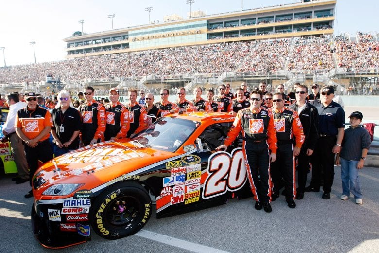 HOMESTEAD, FL - NOVEMBER 16:  (Front: L-R) Tony Stewart, driver of the #20 Home Depot Toyota, crew chief Greg Zipadelli, team owners JD Gibbs and Joe Gibbs pose with the entire crew on the grid prior to the start of the NASCAR Sprint Cup Series Ford 400 at Homestead-Miami Speedway on November 16, 2008 in Homestead, Florida.  (Photo by John Harrelson/Getty Images for NASCAR) | Getty Images