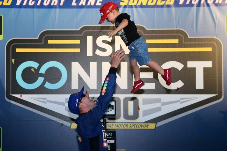 LOUDON, NH - SEPTEMBER 24: Kyle Busch, driver of the #18 M&M's Caramel Toyota, celebrates with his son Brexton in Victory Lane after winning the Monster Energy NASCAR Cup Series ISM Connect 300 at New Hampshire Motor Speedway on September 24, 2017 in Loudon, New Hampshire. (Photo by Sean Gardner/Getty Images) | Getty Images