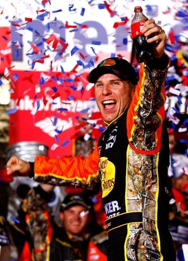 CONCORD, NC - OCTOBER 16: Jamie McMurray, driver of the #1 Bass Pro Shops/Tracker Boats Chevrolet, celebrates in Victory Lane after winning the NASCAR Sprint Cup Series Bank of America 500 at Charlotte Motor Speedway on October 16, 2010 in Concord, North Carolina. (Photo by Jason Smith/Getty Images for NASCAR) | Getty Images