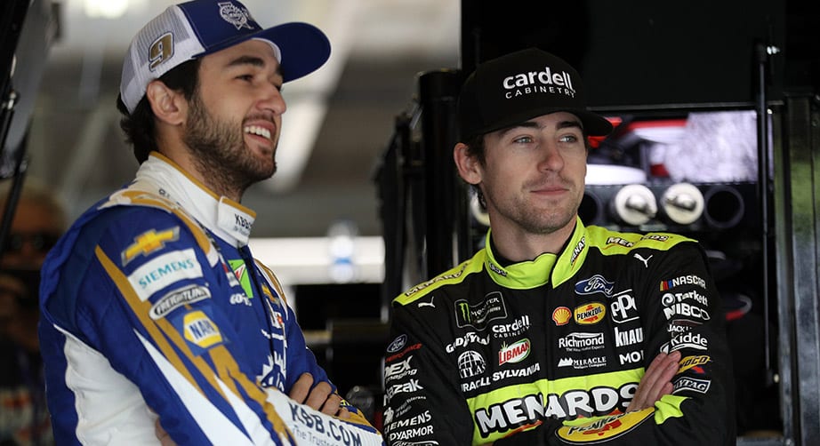 Chase Elliott and Ryan Blaney look on in the garage at Texas.