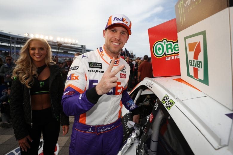 FORT WORTH, TX - MARCH 31: Denny Hamlin, driver of the #11 FedEx Office Toyota, celebrates in victory lane by placing the Winner's sticker on his car after winning the Monster Energy NASCAR Cup Series O'Reilly Auto Parts 500 at Texas Motor Speedway on March 31, 2019 in Fort Worth, Texas. (Photo by Chris Graythen/Getty Images) | Getty Images