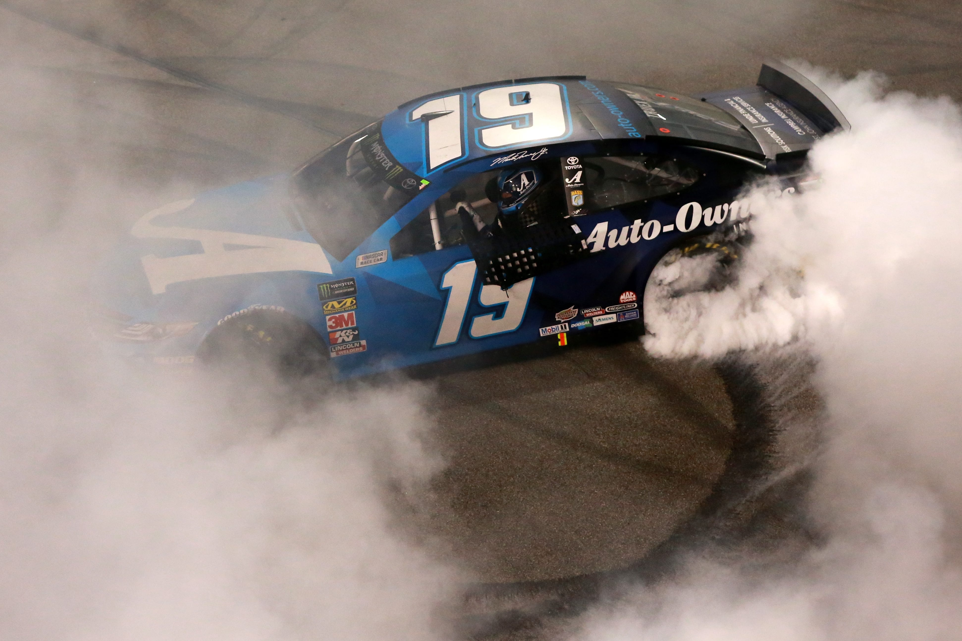 RICHMOND, VA - APRIL 13:  Martin Truex Jr, driver of the #19 Auto Owners Insurance Toyota, does a burnout after winning the Monster Energy NASCAR Cup Series Toyota Owners 400 at Richmond Raceway on April 13, 2019 in Richmond, Virginia.  (Photo by Sean Gardner/Getty Images) | Getty Images