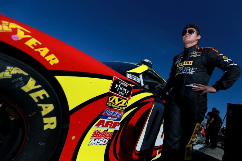 TALLADEGA, AL - APRIL 27: Gray Gaulding, driver of the #08 Panini/NASCARRcgExp/WldwdSftyCnsltng Chev, stands on the grid during qualifying for the NASCAR Xfinity Series MoneyLion 300 at Talladega Superspeedway on April 27, 2019 in Talladega, Alabama. (Photo by Sean Gardner/Getty Images) | Getty Images