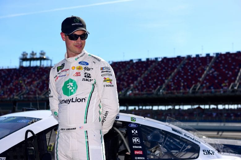 TALLADEGA, AL - APRIL 27:  Joey Logano, driver of the #22 MoneyLion Ford, stands on the grid during qualifying for the Monster Energy NASCAR Cup Series GEICO 500 at Talladega Superspeedway on April 27, 2019 in Talladega, Alabama.  (Photo by Jared C. Tilton/Getty Images) | Getty Images
