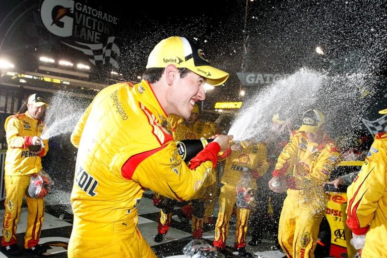 RICHMOND, VA - APRIL 26:  Joey Logano, driver of the #22 Shell-Pennzoil Ford, celebrates with champagne in Victory Lane after winning during the NASCAR Sprint Cup Series Toyota Owners 400 at Richmond International Raceway on April 26, 2014 in Richmond, Virginia.  (Photo by Brian Lawdermilk/NASCAR via Getty Images)