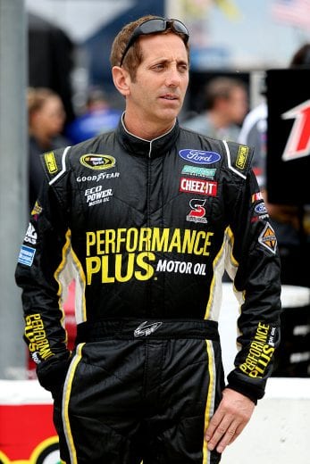 FORT WORTH, TX - NOVEMBER 04: Greg Biffle, driver of the #16 Performance Plus Motor Oil Ford, stands in the garage area during Salute to Veterans Qualifying Fueled by Texas Lottery for the NASCAR Sprint Cup Series AAA Texas 500 at Texas Motor Speedway on November 4, 2016 in Fort Worth, Texas. (Photo by Jerry Markland/Getty Images) | Getty Images