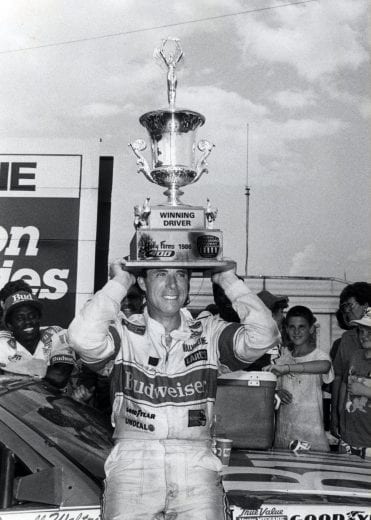 NORTH WILKESBORO, NC - SEPTEMBER 28: Darrell Waltrip has some fun with his trophey after winning the Holly Farms 400. Waltrip woud take home $38,100 for the race.(Photo by Racing Photo Archives/Getty Images)