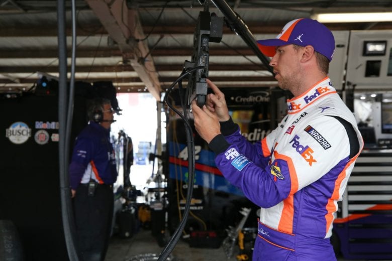 DOVER, DE - MAY 03: Denny Hamlin, driver of the #11 FedEx Office Toyota, stands in the garage during practice for the Monster Energy NASCAR Cup Series Gander RV 400 at Dover International Speedway on May 3, 2019 in Dover, Delaware. (Photo by Matt Sullivan/Getty Images) | Getty Images