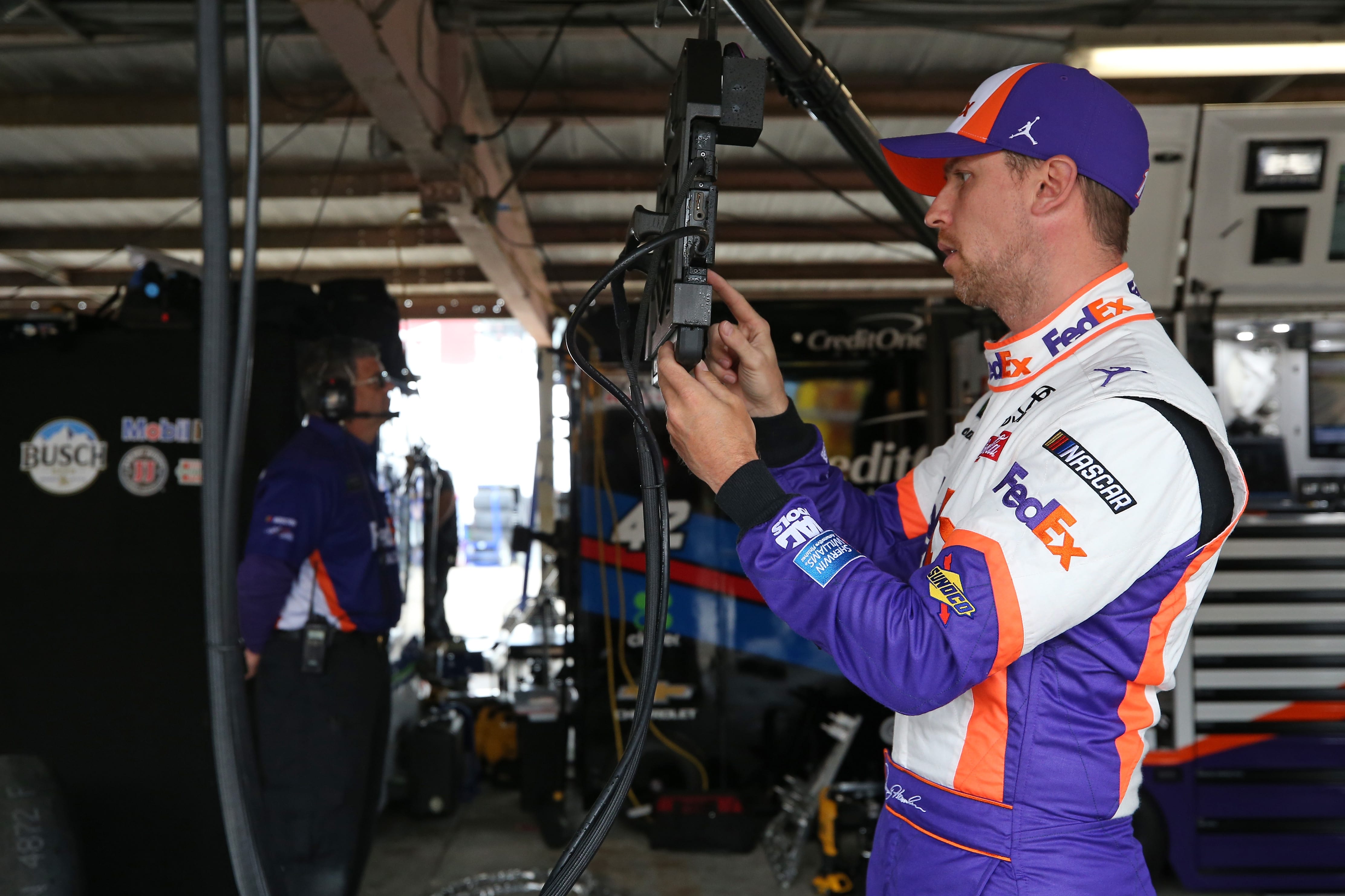 DOVER, DE - MAY 03:  Denny Hamlin, driver of the #11 FedEx Office Toyota, stands in the garage during practice for the Monster Energy NASCAR Cup Series Gander RV 400 at Dover International Speedway on May 3, 2019 in Dover, Delaware.  (Photo by Matt Sullivan/Getty Images) | Getty Images