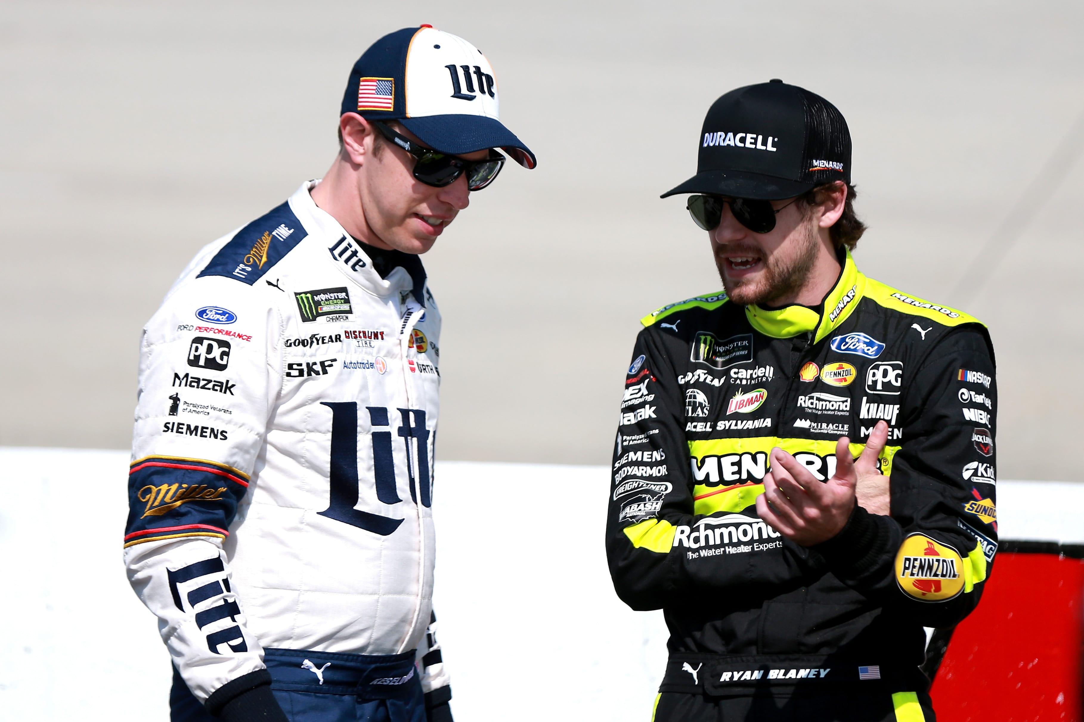 DOVER, DE - MAY 03:  Brad Keselowski, driver of the #2 Miller Lite Ford, and Ryan Blaney, driver of the #12 Menards/Duracell Ford, stand on pit road during qualifying for the Monster Energy NASCAR Cup Series Gander RV 400 at Dover International Speedway on May 3, 2019 in Dover, Delaware.  (Photo by Sean Gardner/Getty Images) | Getty Images
