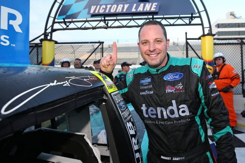 DOVER, DE - MAY 03: Johnny Sauter, driver of the #13 Tenda Heal Ford, poses with the winner's sticker in Victory Lane after winning the NASCAR Gander Outdoors Truck Series JEGS 200 at Dover International Speedway on May 3, 2019 in Dover, Delaware. (Photo by Matt Sullivan/Getty Images) | Getty Images