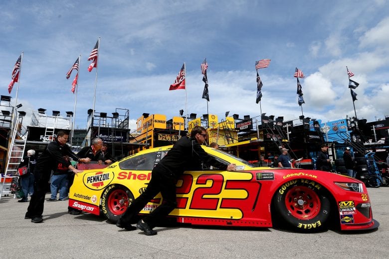 KANSAS CITY, KS - MAY 10:  Crew memberes push the car of Joey Logano, driver of the #22 Shell Pennzoil Ford, through the garage during practice for the Monster Energy NASCAR Cup Series Digital Ally 400 at Kansas Speedway on May 10, 2019 in Kansas City, Kansas.  (Photo by Brian Lawdermilk/Getty Images) | Getty Images