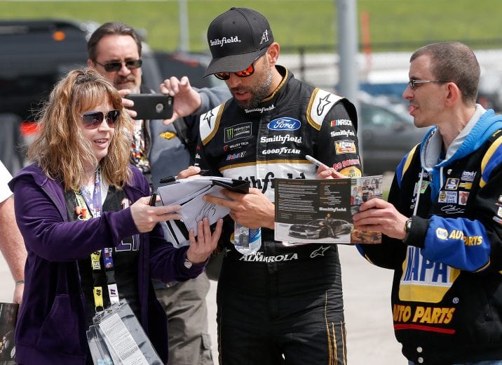 KANSAS CITY, KS - MAY 10:  Aric Almirola, driver of the #10 Smithfield Ford, signs autographs during practice for the Monster Energy NASCAR Cup Series Digital Ally 400 at Kansas Speedway on May 10, 2019 in Kansas City, Kansas.  (Photo by Brian Lawdermilk/Getty Images) | Getty Images