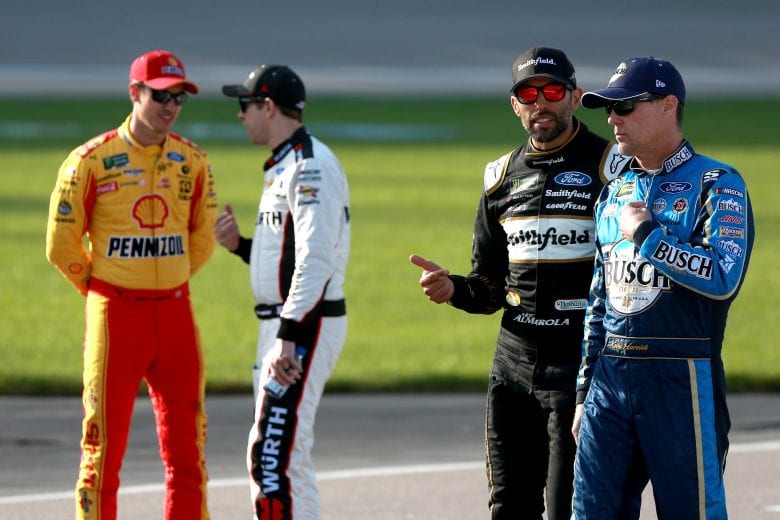 KANSAS CITY, KS - MAY 10:  Aric Almirola, driver of the #10 Smithfield Ford, and Kevin Harvick, driver of the #4 Busch Beer Ford, walk down pit road during qualifying for the Monster Energy NASCAR Cup Series Digital Ally 400 at Kansas Speedway on May 10, 2019 in Kansas City, Kansas.  (Photo by Sean Gardner/Getty Images) | Getty Images