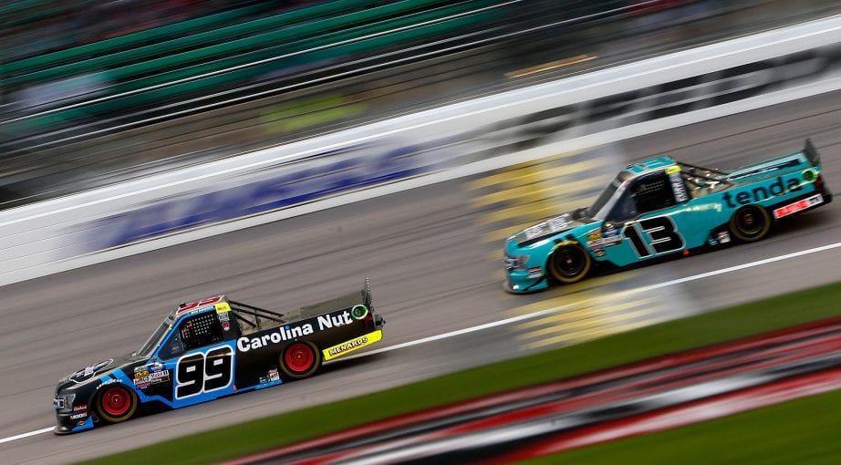 KANSAS CITY, KS - MAY 10:  Ben Rhodes, driver of the #99 Carolina Nut Ford, races, Johnny Sauter, driver of the #13 Tenda Ford, during the NASCAR Gander Outdoors Truck Series Digital Ally 250 at Kansas Speedway on May 10, 2019 in Kansas City, Kansas.  (Photo by Brian Lawdermilk/Getty Images) | Getty Images