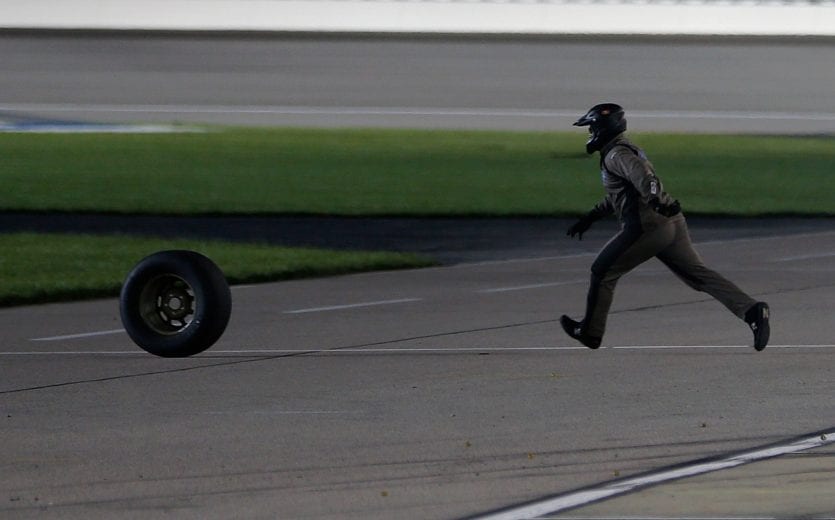 KANSAS CITY, KS - MAY 10:  A crew member runs after a loose tire during a pit stop during the NASCAR Gander Outdoors Truck Series Digital Ally 250 at Kansas Speedway on May 10, 2019 in Kansas City, Kansas.  (Photo by Brian Lawdermilk/Getty Images) | Getty Images