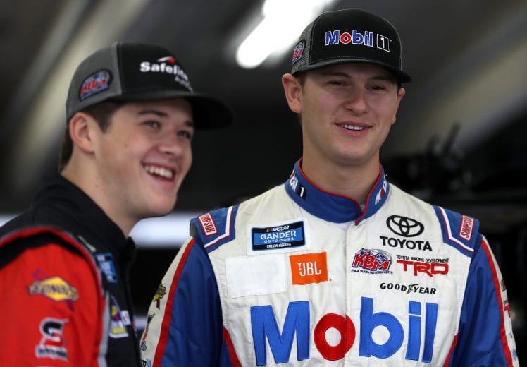 CHARLOTTE, NC - MAY 17:  (L-R) Harrison Burton, driver of the #18 Safelite AutoGlass Toyota, and Todd Gilliland, driver of the #4 Mobil 1 Toyota, talk in the garage area during practice for the NASCAR Gander Outdoors Truck Series North Carolina Education Lottery 200 at Charlotte Motor Speedway on May 17, 2019 in Charlotte, North Carolina.  (Photo by Streeter Lecka/Getty Images) | Getty Images