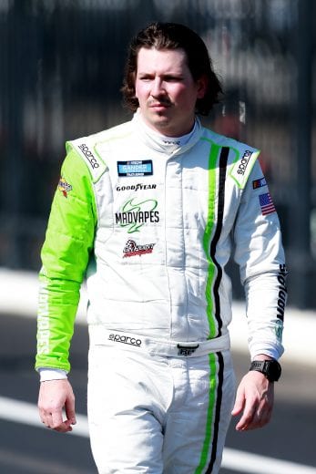 CHARLOTTE, NC - MAY 17:  Brennan Poole, driver of the #30 Madvapes Toyota, walks on pit road during qualifying for the NASCAR Gander Outdoors Truck Series North Carolina Education Lottery 200 at Charlotte Motor Speedway on May 17, 2019 in Charlotte, North Carolina.  (Photo by Sean Gardner/Getty Images) | Getty Images
