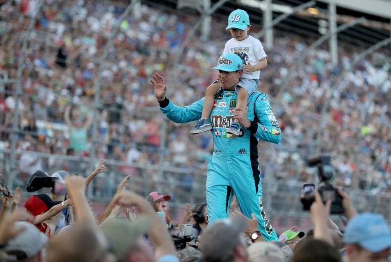CHARLOTTE, NORTH CAROLINA - MAY 18: Kyle Busch, driver of the #18 M&M's Hazelnut Toyota, and his son Brexton walk out during driver introductions before the Monster Energy NASCAR Cup Series All-Star Race at Charlotte Motor Speedway on May 18, 2019 in Charlotte, North Carolina. (Photo by Streeter Lecka/Getty Images) | Getty Images