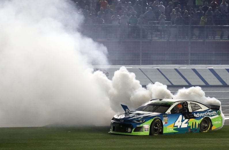 CHARLOTTE, NORTH CAROLINA - MAY 18: Kyle Larson, driver of the #42 Advent Health Chevrolet, celebrates with a burnout after winning the Monster Energy NASCAR Cup Series All-Star Race at Charlotte Motor Speedway on May 18, 2019 in Charlotte, North Carolina. (Photo by Streeter Lecka/Getty Images) | Getty Images