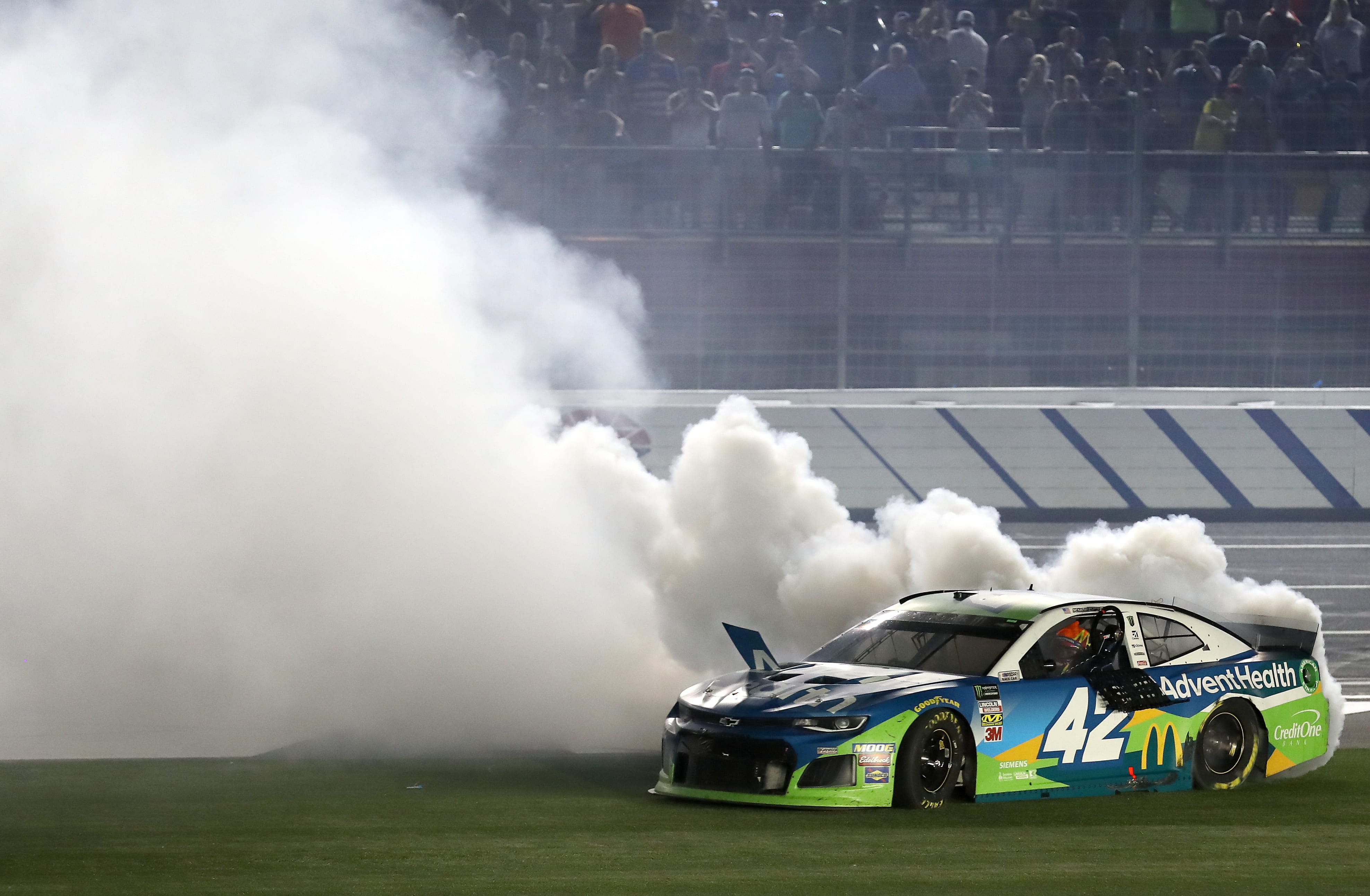 CHARLOTTE, NORTH CAROLINA - MAY 18: Kyle Larson, driver of the #42 Advent Health Chevrolet, celebrates with a burnout after winning the Monster Energy NASCAR Cup Series All-Star Race at Charlotte Motor Speedway on May 18, 2019 in Charlotte, North Carolina. (Photo by Streeter Lecka/Getty Images) | Getty Images