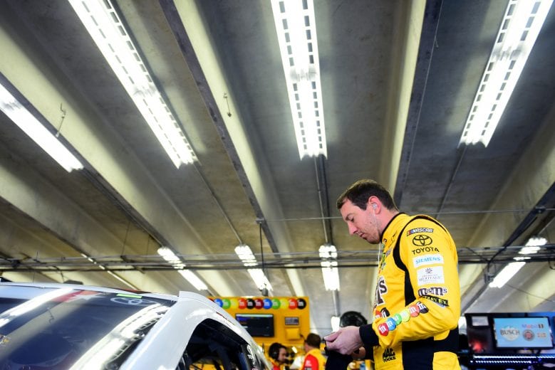 CHARLOTTE, NORTH CAROLINA - MAY 25: Kyle Busch, driver of the #18 M&M's Red White & Blue Toyota, stands in the garage area during practice for the Monster Energy NASCAR Cup Series Coca-Cola 600 at Charlotte Motor Speedway on May 25, 2019 in Charlotte, North Carolina. (Photo by Jared C. Tilton/Getty Images) | Getty Images