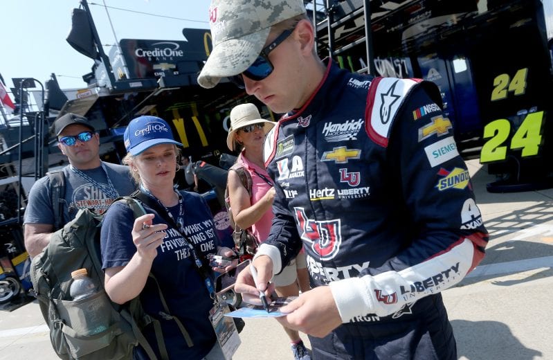 CHARLOTTE, NORTH CAROLINA - MAY 25: William Byron, driver of the #24 Liberty Patriotic Chevrolet, signs autographs in the garage area during practice for the Monster Energy NASCAR Cup Series Coca-Cola 600 at Charlotte Motor Speedway on May 25, 2019 in Charlotte, North Carolina. (Photo by Brian Lawdermilk/Getty Images) | Getty Images