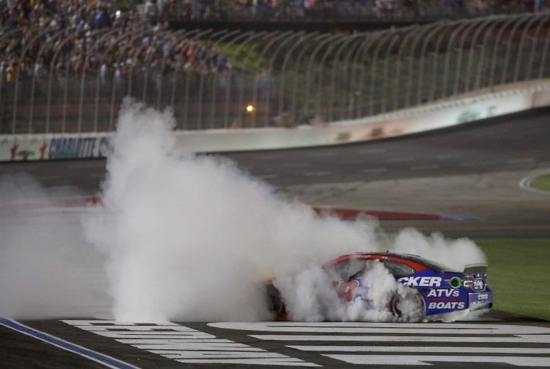 CHARLOTTE, NORTH CAROLINA - MAY 26: Martin Truex Jr., driver of the #19 Bass Pro Shops/TRACKER/USO Toyota, does a burnout after winning the Monster Energy NASCAR Cup Series Coca-Cola 600 at Charlotte Motor Speedway on May 26, 2019 in Charlotte, North Carolina. (Photo by Streeter Lecka/Getty Images) | Getty Images