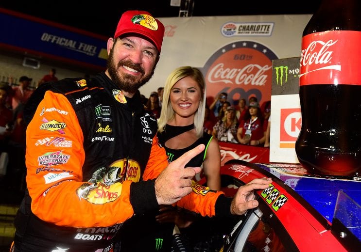 CHARLOTTE, NORTH CAROLINA - MAY 26: Martin Truex Jr., driver of the #19 Bass Pro Shops/TRACKER/USO Toyota, applies the winner's sticker after the Monster Energy NASCAR Cup Series Coca-Cola 600 at Charlotte Motor Speedway on May 26, 2019 in Charlotte, North Carolina. (Photo by Jared C. Tilton/Getty Images) | Getty Images