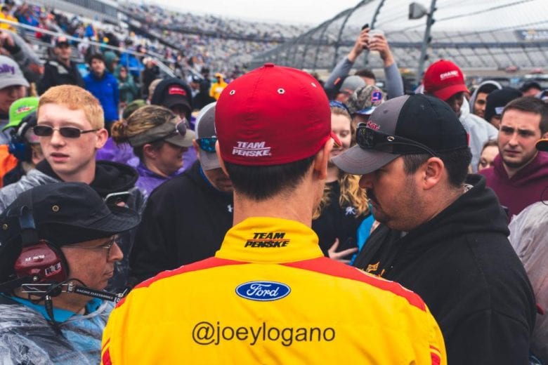 Joey Logano joins the fans in the stands at Dover.