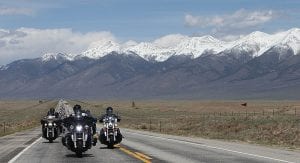 Riders stay in formation with mountainscapes behind them in the Kyle Petty Charity Ride Across America.