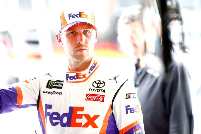 KANSAS CITY, KS - MAY 10:  Denny Hamlin, driver of the #11 FedEx Freight Toyota, stands in the garage during practice for the Monster Energy NASCAR Cup Series Digital Ally 400 at Kansas Speedway on May 10, 2019 in Kansas City, Kansas.  (Photo by Jonathan Ferrey/Getty Images) | Getty Images