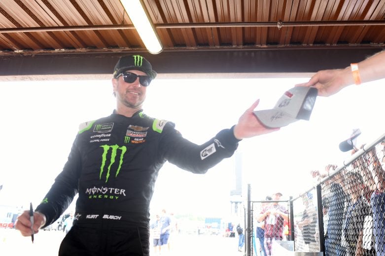 BROOKLYN, MICHIGAN - JUNE 08: Kurt Busch, driver of the #1 Monster Energy Chevrolet, signs autographs on his way to the car during qualifying for the Monster Energy NASCAR Cup Series FireKeepers Casino 400 at Michigan International Speedway on June 08, 2019 in Brooklyn, Michigan. (Photo by Logan Riely/Getty Images) | Getty Images