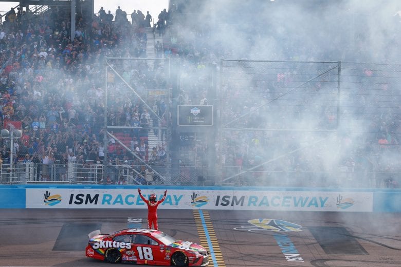 AVONDALE, AZ - MARCH 10: Kyle Busch, driver of the #18 Skittles Toyota, celebrates with a burnout after winning the Monster Energy NASCAR Cup Series TicketGuardian 500 at ISM Raceway on March 10, 2019 in Avondale, Arizona. (Photo by Matt Sullivan/Getty Images) | Getty Images