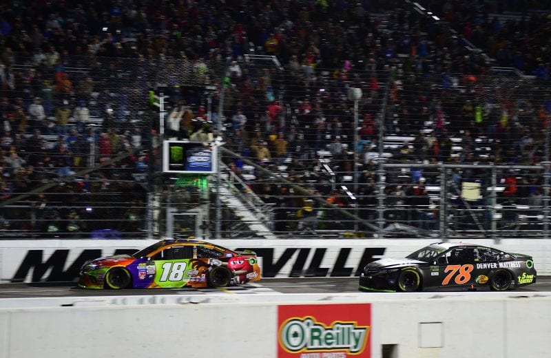 MARTINSVILLE, VA - OCTOBER 29: Kyle Busch, driver of the #18 M&M's Halloween Toyota, takes the checkered flag before Martin Truex Jr., driver of the #78 Furniture Row/Denver Mattress Toyota, to win the Monster Energy NASCAR Cup Series First Data 500 at Martinsville Speedway on October 29, 2017 in Martinsville, Virginia. (Photo by Jared C. Tilton/Getty Images) | Getty Images