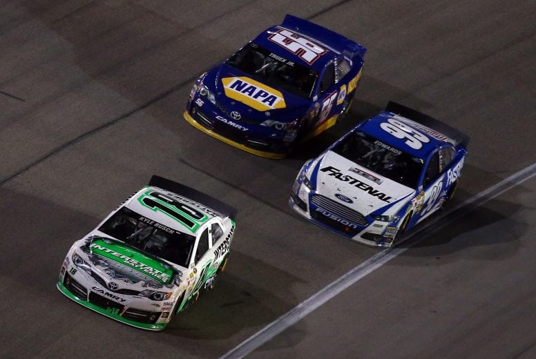 FORT WORTH, TX - APRIL 13: Kyle Busch, driver of the #18 Interstate Batteries Toyota, races Carl Edwards, driver of the #99 Fastenal Ford, and Martin Truex Jr., driver of the #56 NAPA Auto Parts Toyota, during the NASCAR Sprint Cup Series NRA 500 at Texas Motor Speedway on April 13, 2013 in Fort Worth, Texas. (Photo by Jonathan Ferrey/Getty Images for Texas Motor Speedway) | Getty Images
