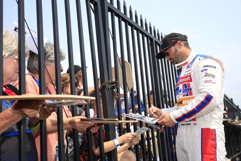 LONG POND, PENNSYLVANIA - JUNE 01: Paul Menard, driver of the #21 Motorcraft/Quick Lane Tire & Auto Center Ford, signs autographs for fans prior to qualifying for the Monster Energy NASCAR Cup Series Pocono 400 at Pocono Raceway on June 01, 2019 in Long Pond, Pennsylvania. (Photo by Chris Trotman/Getty Images) | Getty Images