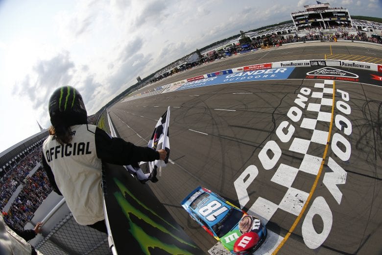LONG POND, PENNSYLVANIA - JUNE 02: Kyle Busch, driver of the #18 M&M's Hazelnut Toyota, crosses the finish line to win the Monster Energy NASCAR Cup Series Pocono 400 at Pocono Raceway on June 02, 2019 in Long Pond, Pennsylvania. (Photo by Jonathan Ferrey/Getty Images) | Getty Images
