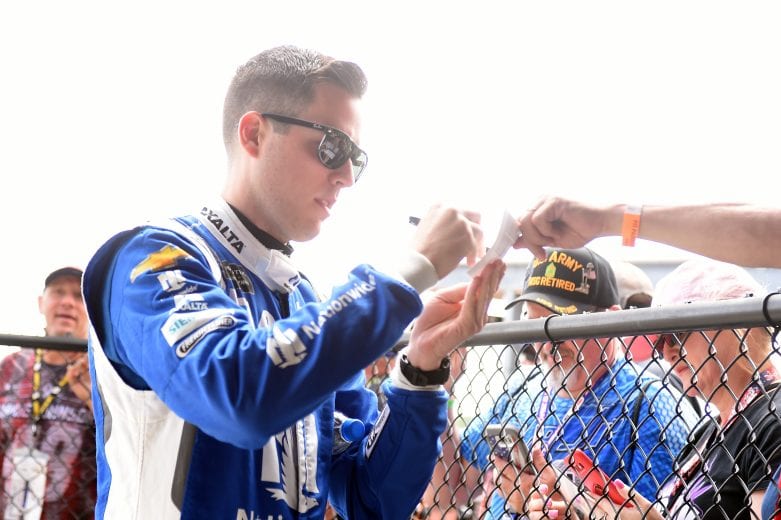 BROOKLYN, MICHIGAN - JUNE 08: Alex Bowman, driver of the #88 Nationwide Chevrolet, signs autographs on his way to the car during qualifying for the Monster Energy NASCAR Cup Series FireKeepers Casino 400 at Michigan International Speedway on June 08, 2019 in Brooklyn, Michigan. (Photo by Logan Riely/Getty Images) | Getty Images