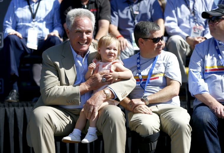 SONOMA, CALIFORNIA - JUNE 23: Fox sports broadcaster Darrel Waltrip holds his grand daughter, Luisa Ellen, at the driver's meeting after being honored on his retiremnt for 19 years of broadcasting NASCAR before the Monster Energy NASCAR Cup Series Toyota/Save Mart 350 at Sonoma Raceway on June 23, 2019 in Sonoma, California. (Photo by Jonathan Ferrey/Getty Images) | Getty Images