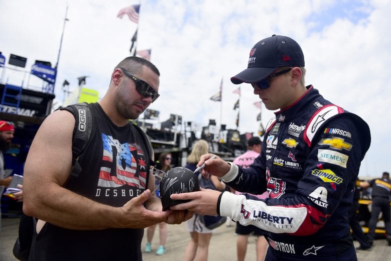 JOLIET, ILLINOIS - JUNE 29: William Byron, driver of the #24 Liberty University Chevrolet, signs an autograph for a fan during practice for the Monster Energy NASCAR Cup Series Camping World 400 at Chicagoland Speedway on June 29, 2019 in Joliet, Illinois. (Photo by Jared C. Tilton/Getty Images) | Getty Images