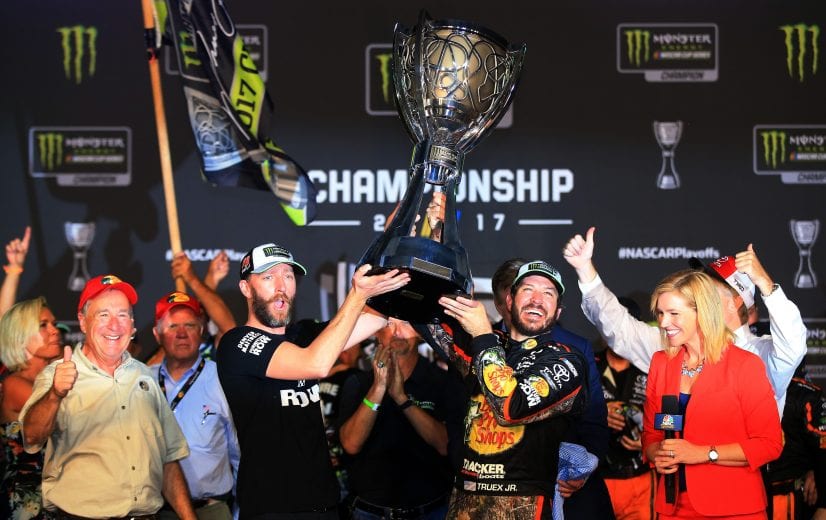 HOMESTEAD, FL - NOVEMBER 19:  Martin Truex Jr., driver of the #78 Bass Pro Shops/Tracker Boats Toyota, celebrates with crew chief Cole Pearn and the trophy in Victory Lane after winning the Monster Energy NASCAR Cup Series Championship and the Monster Energy NASCAR Cup Series Championship Ford EcoBoost 400 at Homestead-Miami Speedway on November 19, 2017 in Homestead, Florida.  (Photo by Chris Trotman/Getty Images) | Getty Images
