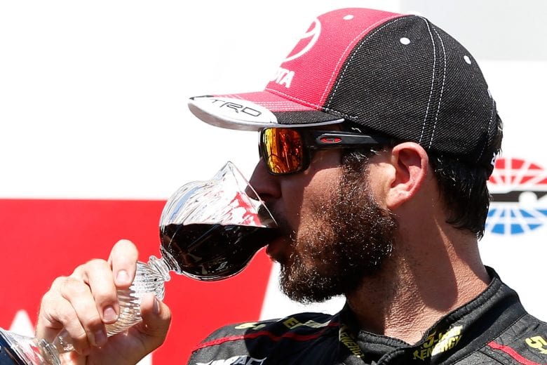 SONOMA, CA - JUNE 24:  Martin Truex Jr., driver of the #78 5-hour ENERGY/Bass Pro Shops Toyota, celebrates in victory lane by drinking wine after winning the Monster Energy NASCAR Cup Series Toyota/Save Mart 350 at Sonoma Raceway on June 24, 2018 in Sonoma, California.  (Photo by Brian Lawdermilk/Getty Images) | Getty Images
