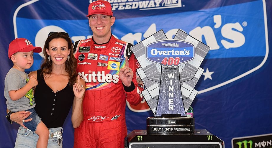 JOLIET, IL - JULY 01: Kyle Busch, driver of the #18 Skittles Red White & Blue Toyota, poses with his wife, Samantha, and their son, Brexton, after winning the Monster Energy NASCAR Cup Series Overton's 400 at Chicagoland Speedway on July 1, 2018 in Joliet, Illinois. (Photo by Jared C. Tilton/Getty Images) | Getty Images