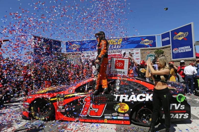 SONOMA, CALIFORNIA - JUNE 23: Martin Truex Jr., driver of the #19 Bass Pro Shops Toyota, celebrates in Victory Lane after winning the Monster Energy NASCAR Cup Series Toyota/Save Mart 350 at Sonoma Raceway on June 23, 2019 in Sonoma, California. (Photo by Jonathan Ferrey/Getty Images) | Getty Images