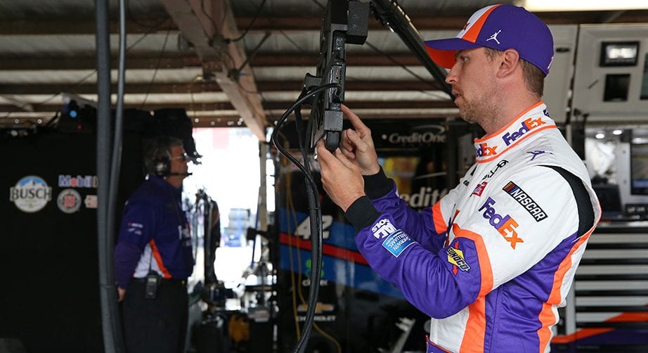 DOVER, DE - MAY 03:  Denny Hamlin, driver of the #11 FedEx Office Toyota, stands in the garage during practice for the Monster Energy NASCAR Cup Series Gander RV 400 at Dover International Speedway on May 3, 2019 in Dover, Delaware.  (Photo by Matt Sullivan/Getty Images) | Getty Images