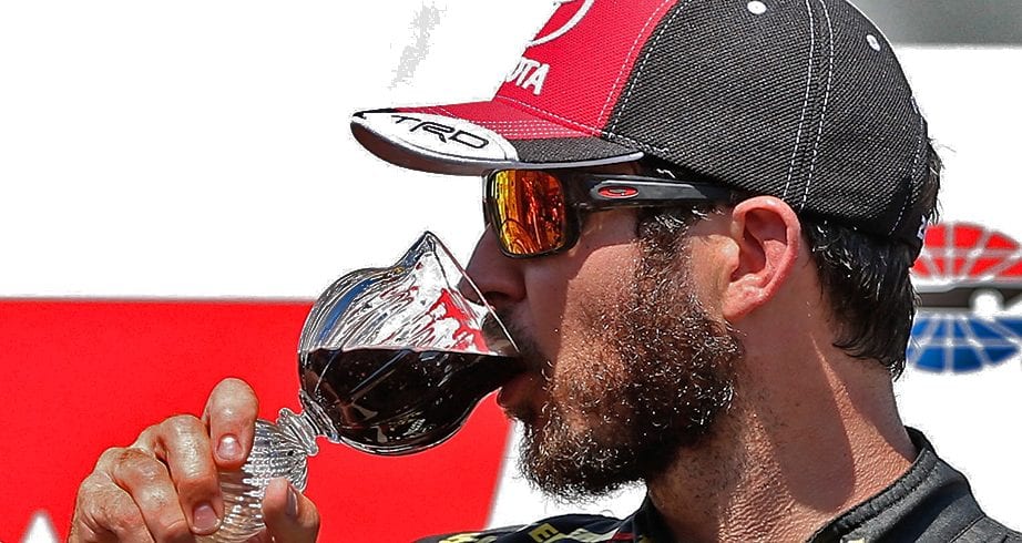 SONOMA, CA - JUNE 24: Martin Truex Jr., driver of the #78 5-hour ENERGY/Bass Pro Shops Toyota, celebrates in victory lane by drinking wine after winning the Monster Energy NASCAR Cup Series Toyota/Save Mart 350 at Sonoma Raceway on June 24, 2018 in Sonoma, California. (Photo by Brian Lawdermilk/Getty Images) | Getty Images